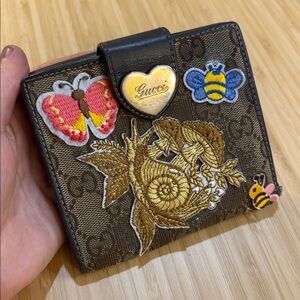Gucci Brown and Gold Wallet with patches attached